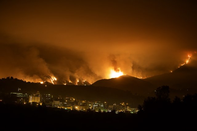 Flames Ravaging the Hills Above the City