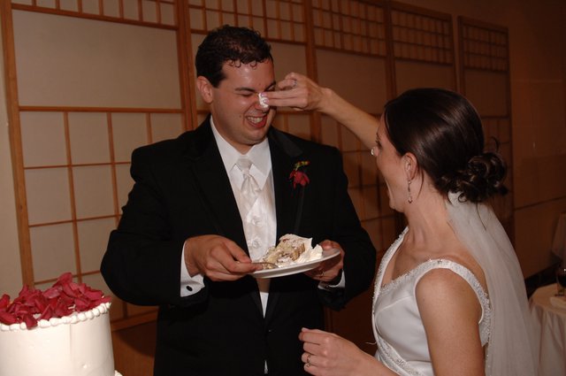 Bride Smashes Cake on Groom's Nose at Reception