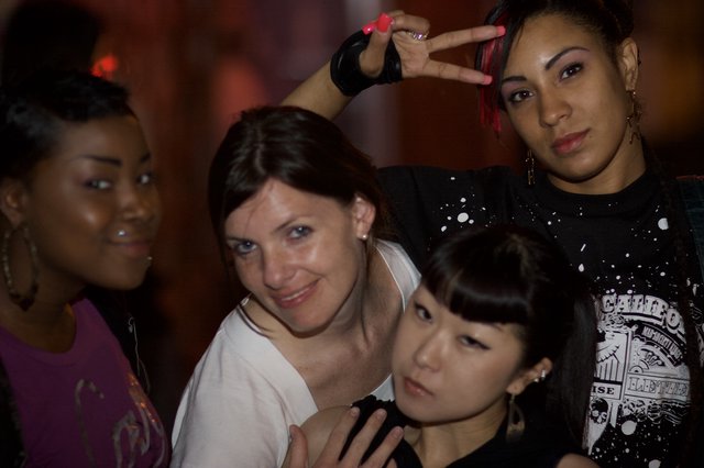 Four Women Posing Together at Nightclub Event