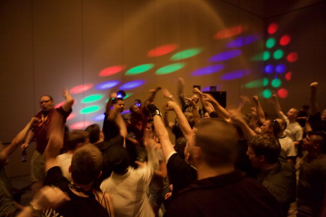 Nightclub Crowd Dancing Under Colorful Lights
