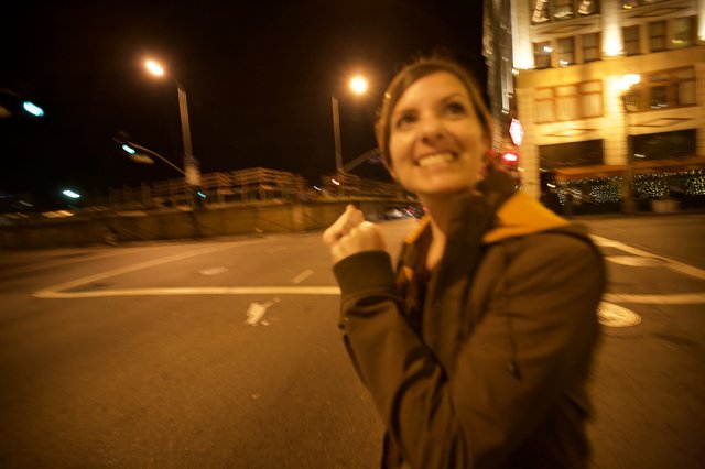 Joyful Woman Celebrating on City Streets at Night