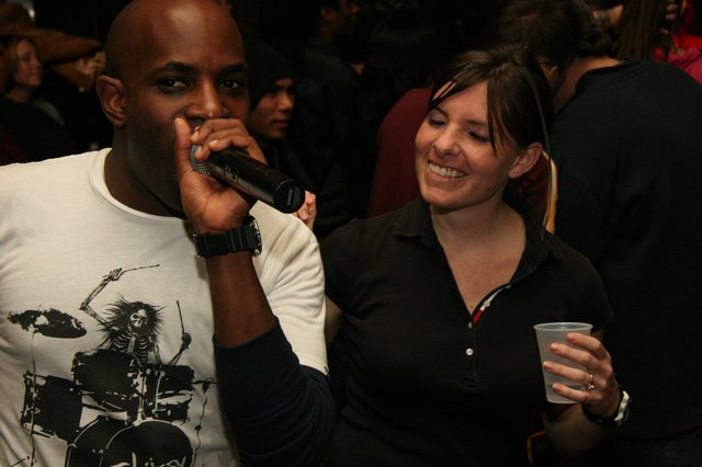 MC Q Performs at Lively Indoor Event with Crowd