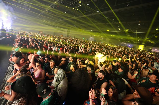 Massive Indoor Crowd Erupts Under Green Laser Lights