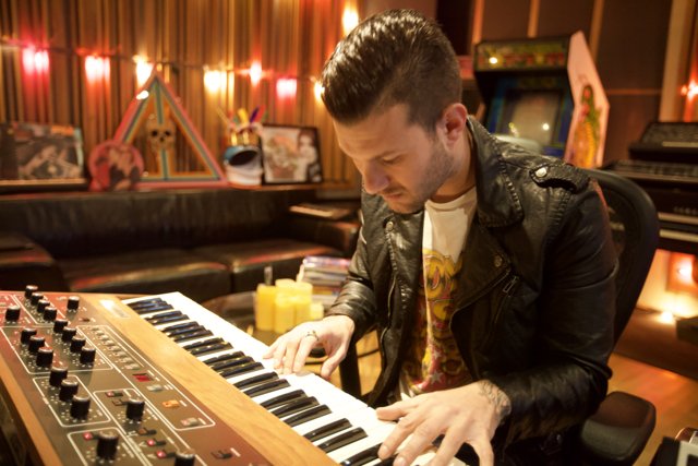 Man in a Leather Jacket Playing Electronic Keyboard