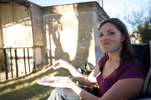 Woman Enjoying Outdoor Backyard Barbecue at Golden Hour