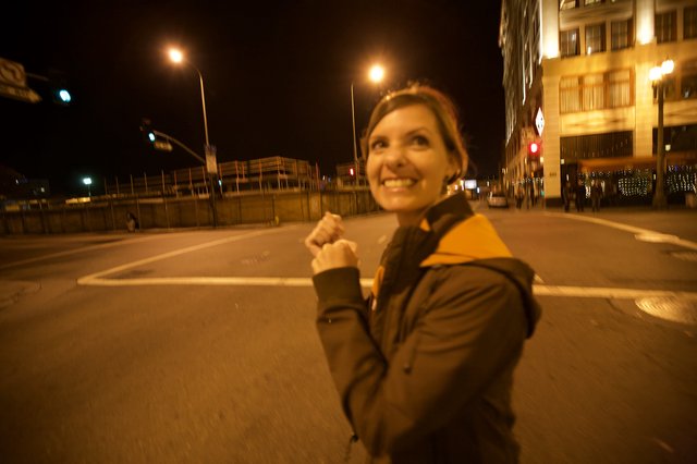 Joyful Woman Celebrating on City Streets at Night