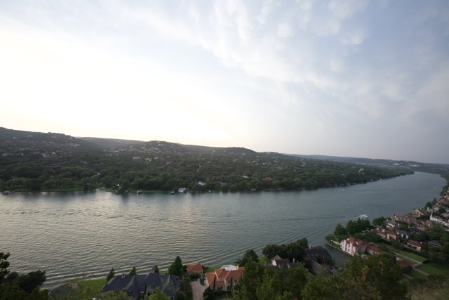 Panoramic View of Lake Austin Caption: A stunning aerial shot of Lake Austin in Texas featuring five buildings, two boats, and a breathtaking view of the surrounding landscape.