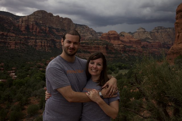 Couple Embracing Before Sedona's Dramatic Storm Skies
