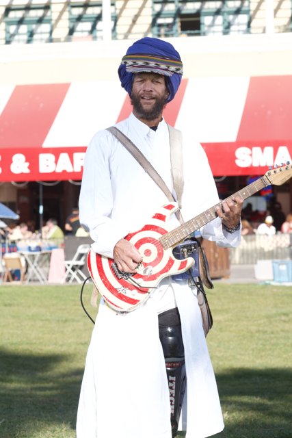 Turbaned Musician Strums His Guitar Outdoors