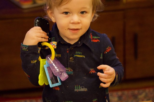 Toddler Playing with Toy Keys and Phone at Christmas