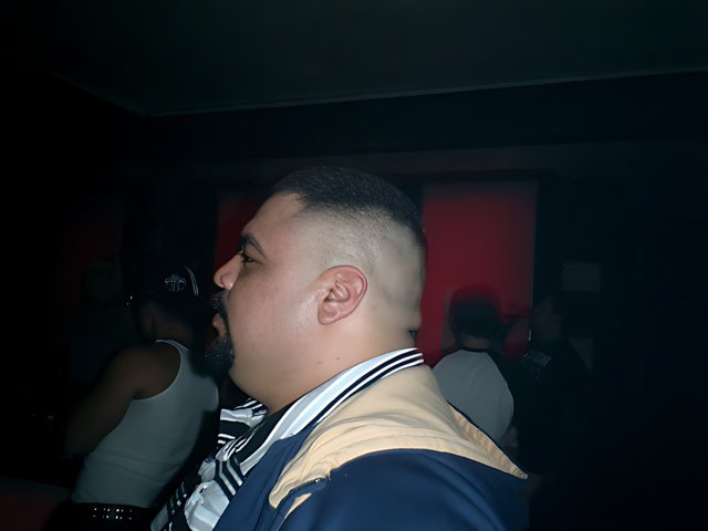 Shaved Head in the Night Club