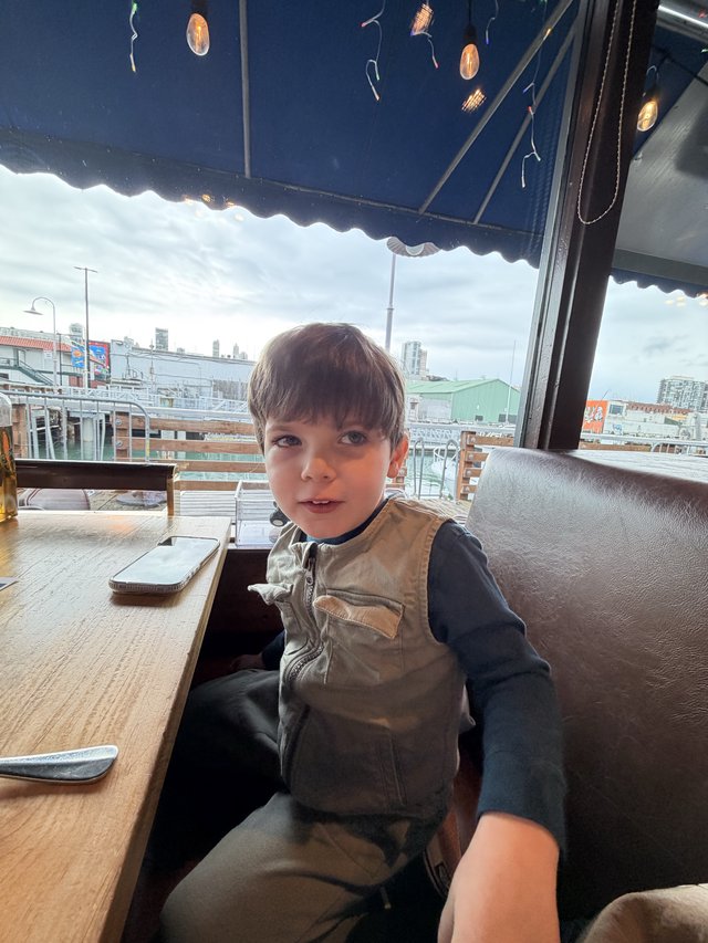 Young Boy at Urban Rooftop Café