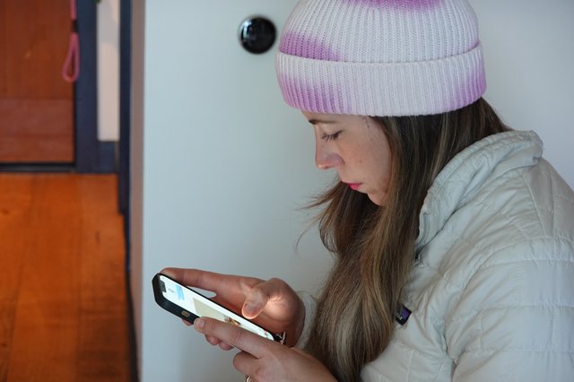 Young Woman Using Smartphone in Winter Coat