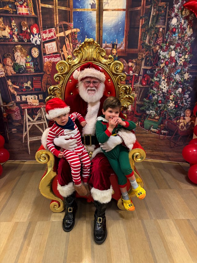 Two Children Visit Santa in His Christmas Workshop