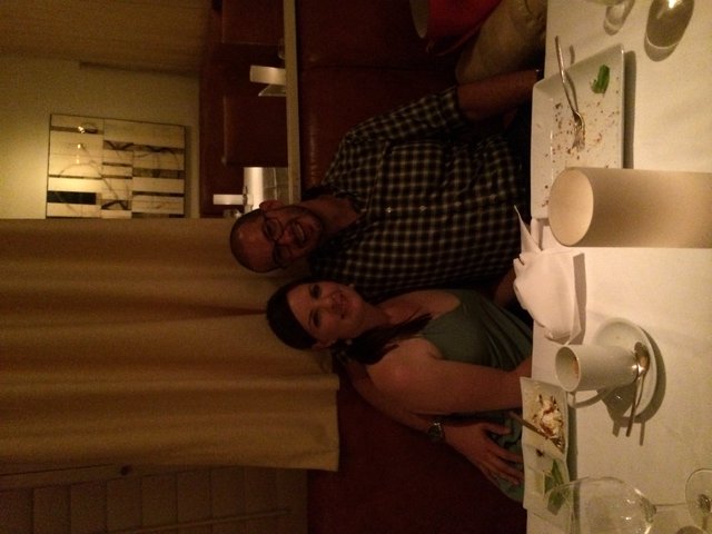 Couple Smiling Together at Romantic Restaurant Dinner