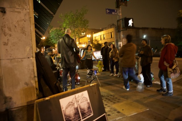 Nighttime Gathering on the City Sidewalk