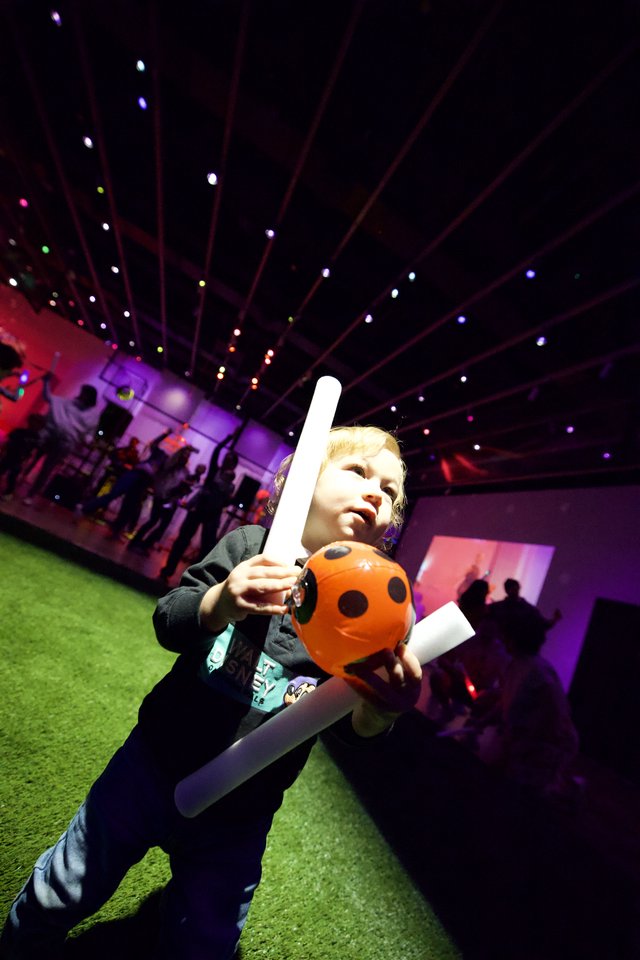 Young Child Enjoying Halloween-Themed Baby Rave with Light Sword