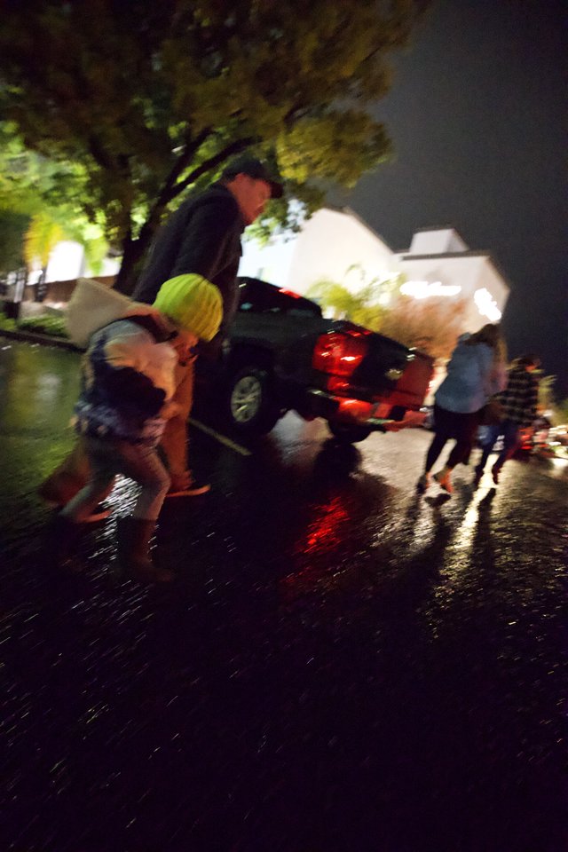 Nighttime Emergency Scene with Wet Streets and Responders