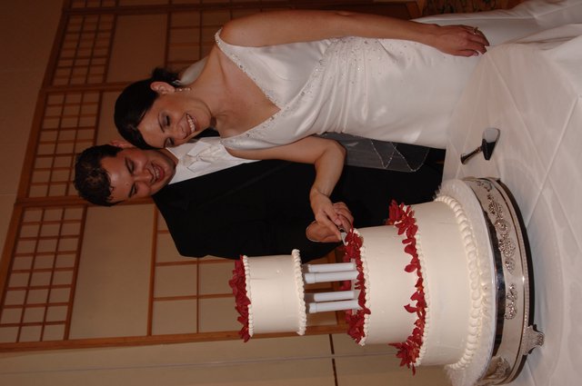 Bride and Groom Cut Their Wedding Cake Together