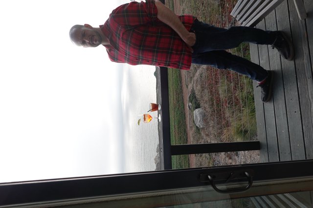 Man Enjoying Coastal Drinks at Scenic Overlook