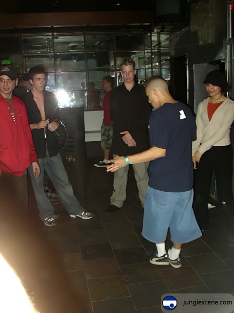 Group of People Gathered Around Man Playing Game