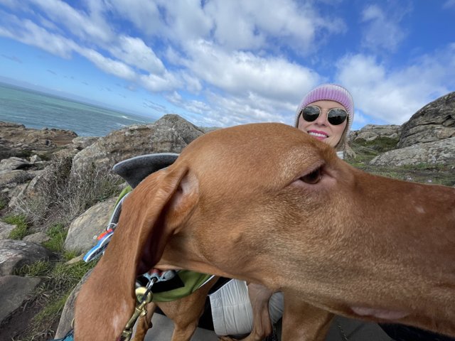 Woman and her Vizsla Taking a Selfie by the Ocean