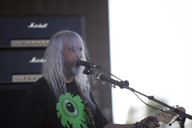 Musical Performance by a White Haired Guitarist