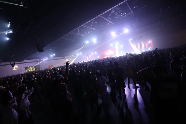 Massive Indoor Rave Crowd Surges Toward Blazing Stage