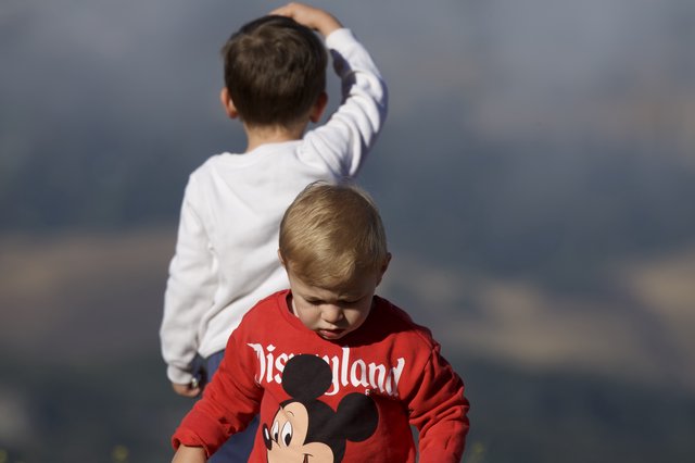 Two Young Boys Exploring Under Stormy Skies