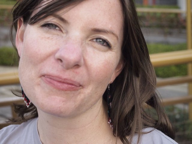 Candid Portrait of Penelope with Beaded Earrings Outdoors