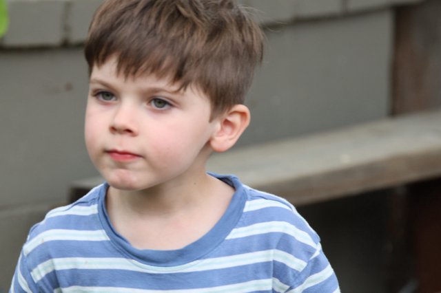Thoughtful Young Boy in Striped Shirt