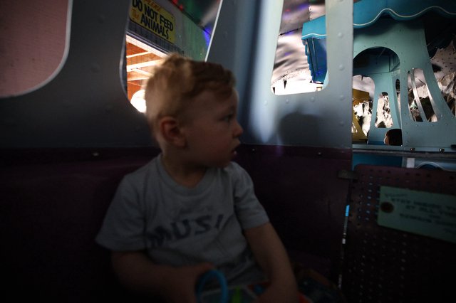 Young Child Playing in Dimly Lit Fantasyland Setting