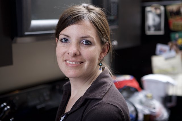 Smiling Woman with Blue Eyes in Office Setting