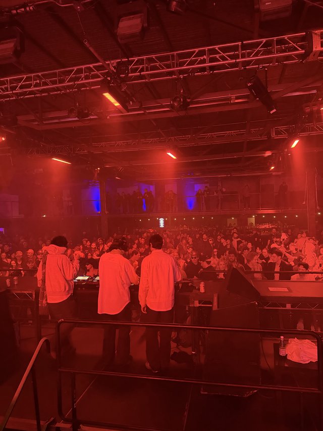 Electronic Music Event Under Dramatic Red Stage Lighting