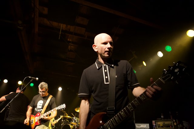 Bald-Headed Guitarist Rocks the Stage
