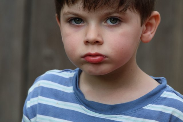 Young Boy in Blue Striped Shirt - Close Portrait