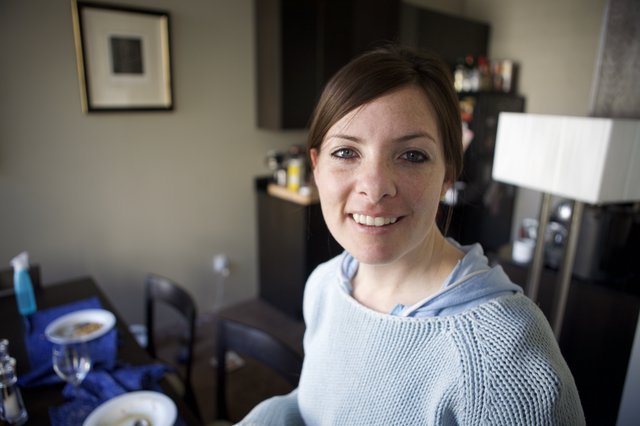 Smiling Woman in Blue Hoodie at Home