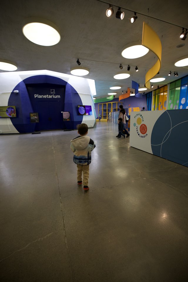 Child Explores Modern Interactive Science Museum Planetarium