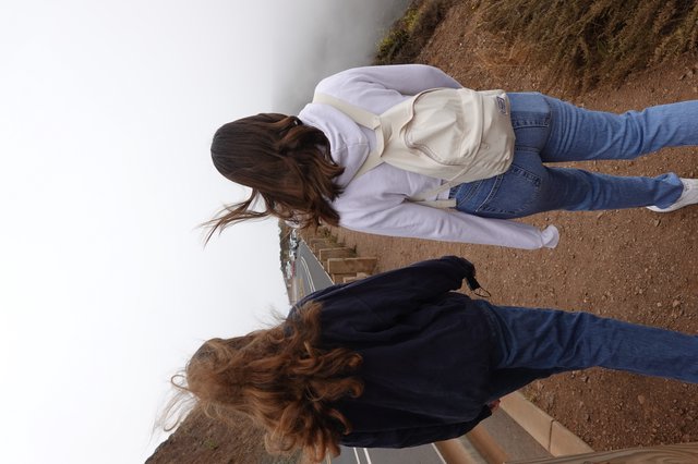 Two Women Walking in Strong Coastal Wind
