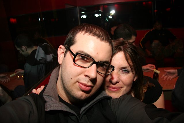 Couple Poses Together at Dimly Lit Nightclub