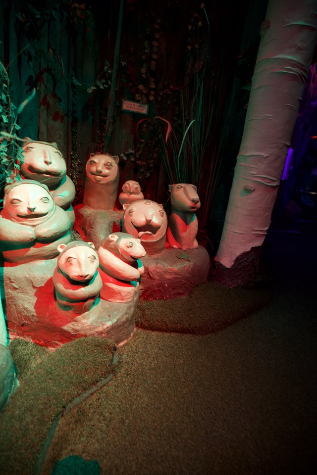 Whimsical Clay Ferret Sculptures in Themed Display