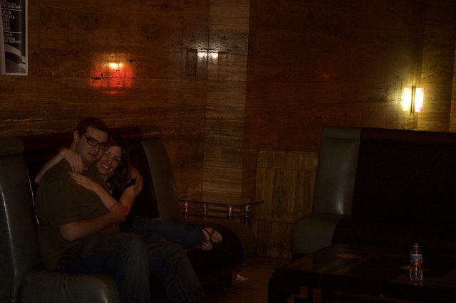 Couple Cuddling in Dimly Lit Lounge Bar