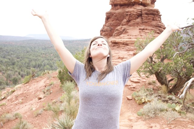 Triumphant Woman Celebrates Atop Sedona Red Rocks