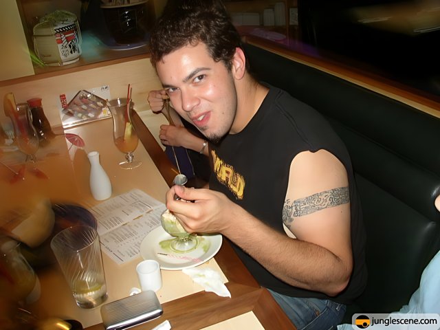 Tattooed Man Enjoying His Meal