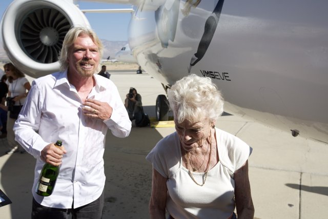 Richard Branson and companions beside their aircraft