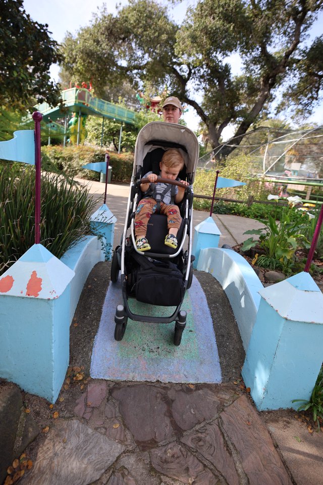 Parent and Child Navigate Whimsical Garden Bridge