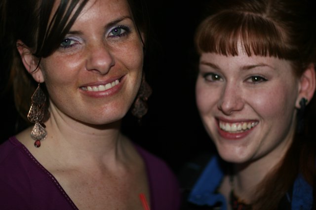 Two Smiling Women at a Nighttime Social Event