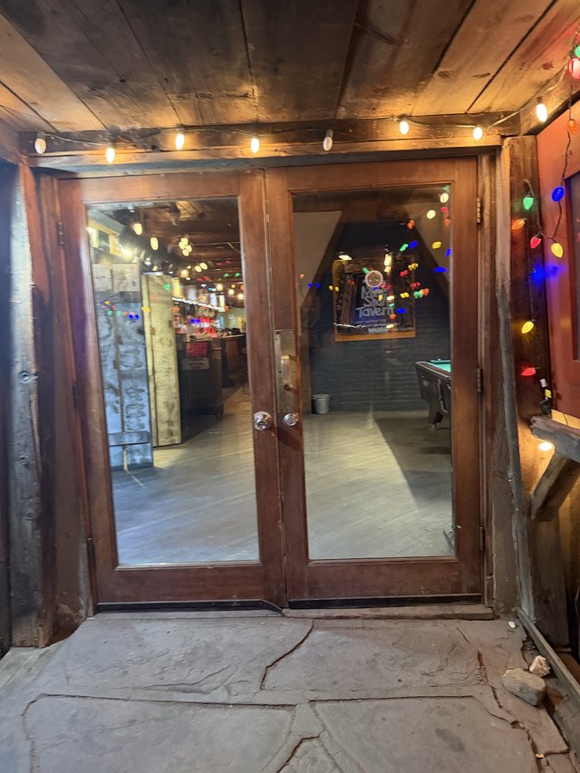 Rustic Tavern Entrance Decorated with Festive String Lights