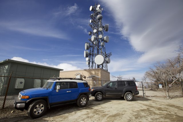 Suvs Parked in Front of Cell Tower