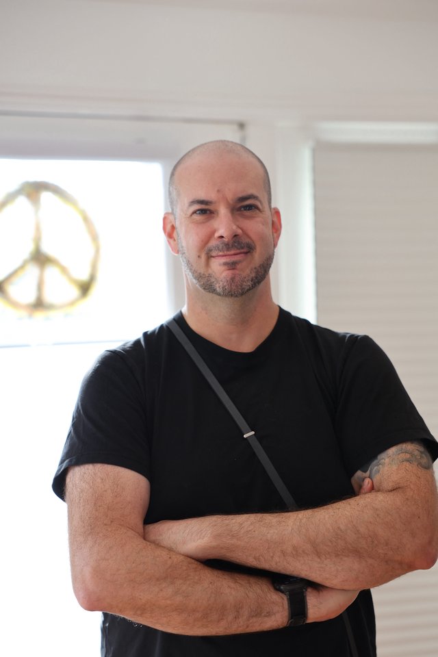 Portrait of Man in Black Shirt with Peace Sign
